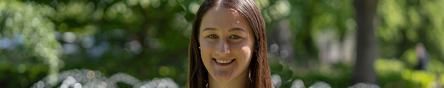 Female student smiling in the gardens